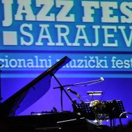 A dimly lit stage at the Sarajevo Jazz festival with piano and microphone