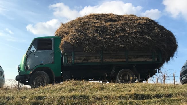 An old Bosnian truck with a load of straw on the back