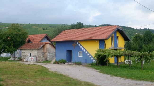 A house near Bihać in Bosnia painted entirely in the colours of the flag of Bosnia and Herzegovina
