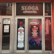 The entrance to Cinema Sloga Club, with drink and other adverts on the door