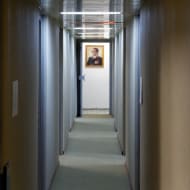 A long corridor in Tito's bunker with his portrait hanging on the wall at the end